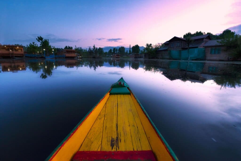 Kashmir in May and June with lush green valleys and snow-capped mountains.