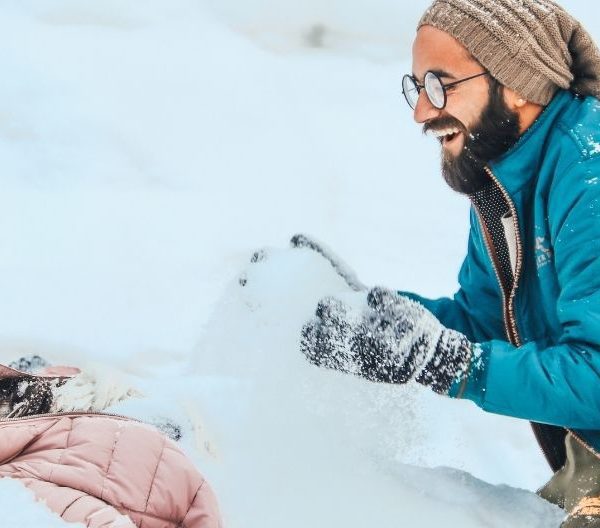 Wedding photoshoot in Gulmarg Kashmir — couple posing in the snowy meadows with panoramic Himalayan backdrop, a popular destination for photography and pre-wedding shoots