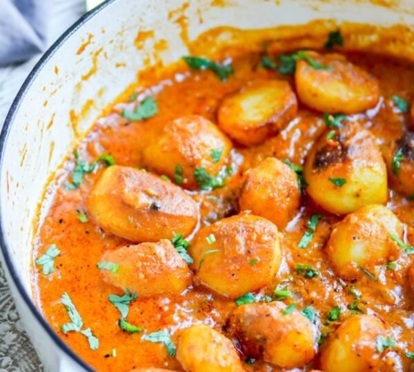 Kashmiri Dum Aloo baby potatoes slow cooked in rich spicy tomato gravy