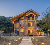 Zostel Pahalgam budget hostel surrounded by snow capped mountains and lush green valleys in Kashmir