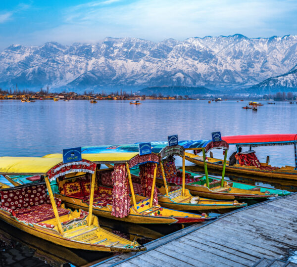 Dal Lake Srinagar in December with snow covered surroundings frozen lake surface and Shikara boats