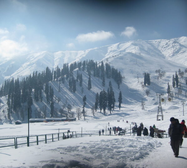 Gulmarg Kashmir in a normal winter season with fresh powder snow covered ski slopes and skiers enjoying the Himalayan slopes