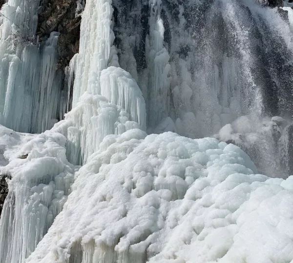 Drang Ferozpur Nallah frozen waterfall Kashmir in winter with ice covered cascade sparkling in sunlight near Gulmarg
