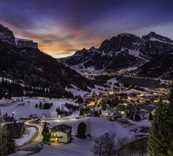 Kashmir winter wonderland snow covered houses fields and pine trees surrounded by Himalayan mountains in Gulmarg